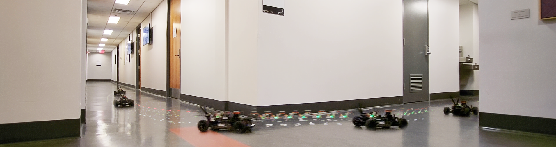 F1TENTH race cars driving through an indoor course in Levine Hall.
